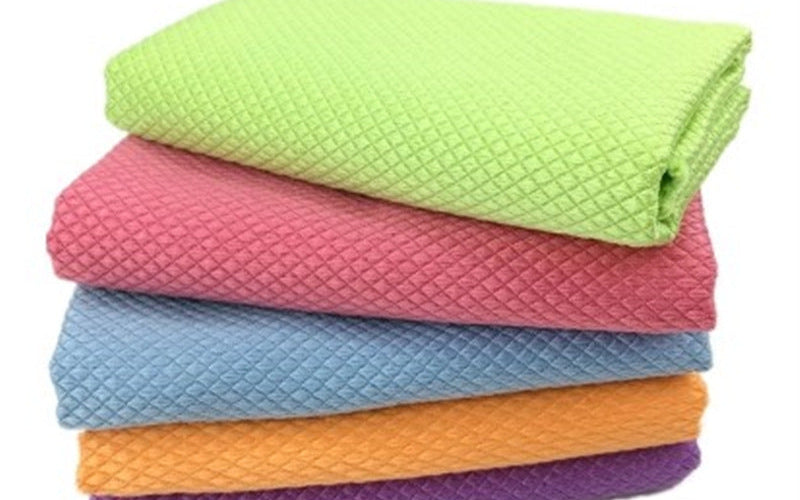Five folded microfibre cloths in assorted colours, stacked on a white background.