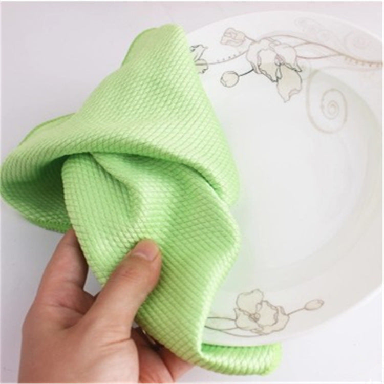 A green microfibre cloth held in one hand, its diamond weave visible up close.