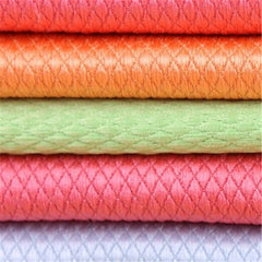 Close-up of the diamond-patterned microfibre weave of the folded cloths.
