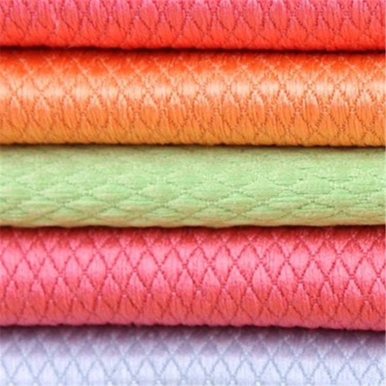Close-up of the diamond-patterned microfibre weave of the folded cloths.